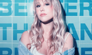 Singer Dayna Reid posing against wall with Better than Blue text